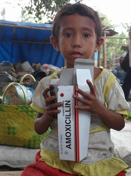 A young girl helps her mother at a medicine stall in a market in Bowae, Flores. Inappropriate self-treatment has led to very high levels of antibiotic resistance in Indonesia (Elizabeth Pisani) Medicine for a sick system